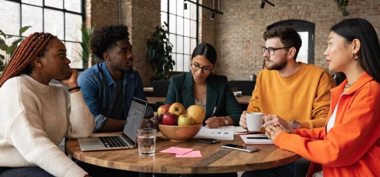 Diverse employees collaborating in a modern office, symbolizing workplace fairness and pay equity
