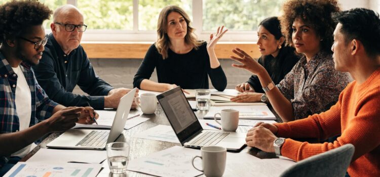 Diverse business leaders collaborating on change management strategies in a modern office setting